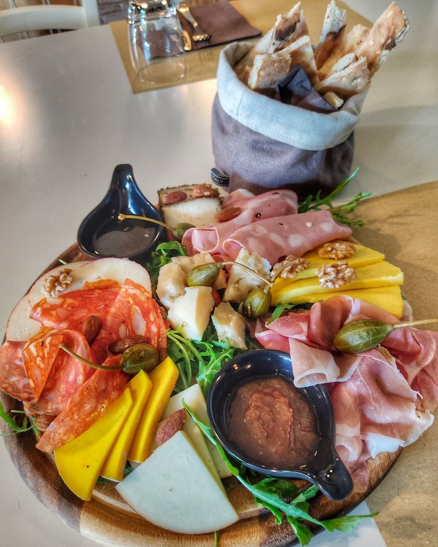 A board of cured meats and cheeses