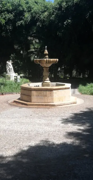 Fontana in pietra all'ombra degli alberi di Villa Bellini